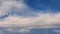 Panoramic cloudscape and the tiny moon on the blue sky. Fluffy white clouds aerial composition. Misty overcast cumulus shapes