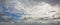 Panoramic cloudscape white and grey altocumulus clouds