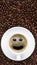 Panoramic coffee background of a cup of black coffee with smiling face coffee bubble on background of roasted arabica coffee beans