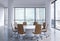 Panoramic conference room in modern office in Moscow, Russia. Brown chairs and a white round table.