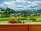 Panoramic countryside mountain view from balcony with red flowers