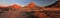 Panoramic, desert landscape of famous rounded red, granite rocks of Spitzkoppe area in early sunrise against blue sky. Picturesque