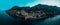 Panoramic drone shot of the illuminated village and commune of Positano, Italy stretching over hills