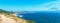 Panoramic elevated view of scenic rugged Northern California ocean coast on a sunny day from hiking trail that follows the steep