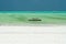 Panoramic endless view over white sand on turquoise green water with wooden traditional dau sailing boats - Paje beach, Zanzibar