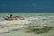 Panoramic endless view over white sand on turquoise green water with wooden traditional dau sailing boats - Paje beach, Zanzibar