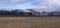 Panoramic Icelandic lava desert landscape with top of Eyjafjallajokull glacier and volcano, partialy covered in clouds