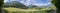 Panoramic idyll: Grass and meadow, mountains and blue sky. Bad Reichenhall, Bavaria, Germany