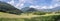 Panoramic idyll: Grass and meadow, mountains and blue sky. Bad Reichenhall, Bavaria, Germany