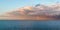 Panoramic image of a heavy rain storm and clouds over the coast of Denmark with a rainbow emerging over the Baltic Sea