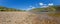 Panoramic image over the half-dried Rhine with barge in the navigation channel