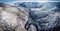 Panoramic image of a winding road from a high mountain pass in T
