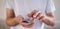 Panoramic image of young caucasian man using apps on a touchscreen smartphone - Hands close-up