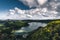 Panoramic landscape with aerial view on beautiful blue green crater lake Lagoa das Furnas and village Furnas with