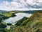 Panoramic landscape with aerial view on beautiful blue green crater lake Lagoa das Furnas and village Furnas with