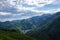 Panoramic landscape of Almaty mountains with cloudy stormy clouds.