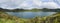 Panoramic landscape with beautiful blue crater lake Lagoa do Fogo from top of the hill on hiking trail. Lake of Fire is