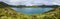 Panoramic landscape with beautiful blue crater lake Lagoa do Fogo from top of the hill on hiking trail. Lake of Fire is