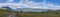 Panoramic landscape with beautiful river Lulealven, snow capped mountain, birch tree and footpath of Kungsleden hiking trail near