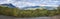 Panoramic landscape with beautiful river Lulealven, snow capped mountain and yellow birch tree. Kungsleden hiking trail near