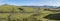 Panoramic landscape with blue river stream, green hills, snow-capped mountains, meadow and lush moss. Laugavegur hiking