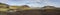 Panoramic landscape with colorful tents at camping site on blue Alftavatn lake with green hills and glacier in beautiful