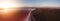 Panoramic landscape of the evening salt lake. The setting sun over the healthy pink salt farm. Aerial view