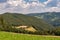 Panoramic landscape of an idyllic farmland countryside with few clouds in the sky and a downhill view