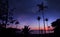 Panoramic landscape of man standing on the coconut beach with a million stars