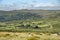 Panoramic landscape view across Dartmoor National Park in Summer with wide views of several tors and valleys