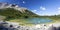Panoramic Landscape View of Beautiful Elk Lake, Green Alpine Evergreen Forest and Rugged Peaks of Sawback Mountain Range