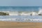 Panoramic landscape view of large foamy sea wave from Arabian Sea splashing with spray of water droplets in the air at Gokarna