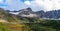 Panoramic landscape view of snow capped mountains and autumn color trees