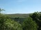 Panoramic landscape view between spring trees in the colden valley above hardcastle crags in west yorkshire