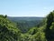 Panoramic landscape view between spring trees in the colden valley above hardcastle crags in west yorkshire