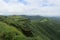 Panoramic landscape view of strong perimeter wall of ancient Sinhgad fort in beautiful lush green Sahyadri mountains in Pune,