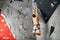 Panoramic man bouldering at an indoor climbing centre.