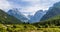 Panoramic of Mangart-Jalovec Mountain Massive in the Julian Alps inside beautiful Landscape. Log pod Mangartom, Bovec, Slovenia,