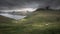 Panoramic mountain landscape of Faroe Islands with sheep in front of village Funningur at the coast of island Eysturoy