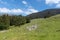 Panoramic mountain view with a small cabin in the background