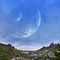 Panoramic mountains and two planets in sky. Fantastic world, birds flying against the background planets of moons. Sunset is