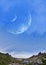 Panoramic mountains and two planets in sky. Fantastic world, birds flying against the background planets of moons. Sunset is