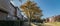 Panoramic multi-story riverside apartment complex fall foliage i