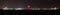 Panoramic night view of oil refinery buildings, towers and pipes