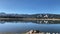 Panoramic panning mountain lake spring morning dawn calm reflection lakeside shoreline