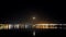 Panoramic panning time lapse at night with oil industry and moon reflection over sea in Aliaga district, Izmir.