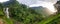 Panoramic photo of beautiful waterfal and tea plantation on the mountain hilltop