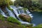 Panoramic photo landscape / Waterfall hidden in the tropical jungle surrounded by a natural swimming pool with clear fresh water.