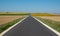 Panoramic photo of sunflower fields in the distance, with road dissecting, near Chenonceau in the Loire Valley, France.