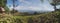 panoramic photo of the view from a hill in Papua showing views of a lake in the distance.